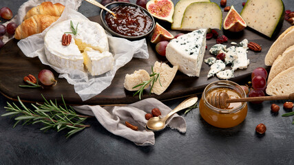 Cheese assortment on dark background.
