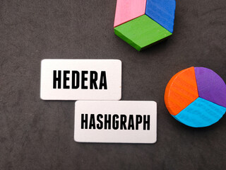 Colored cube written with text HEDERA HASHGRAPH on black background.Business concept.