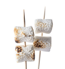 Skewers with tasty grilled marshmallow on white background, closeup