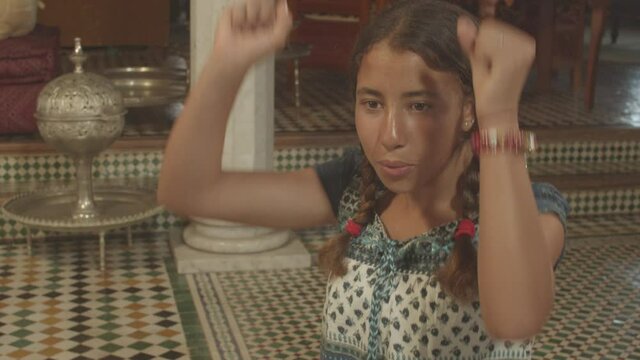 Young girl enthusiastically watching TV and supporting her teammates. Close up.