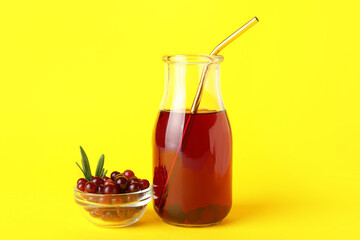 Fototapeta na wymiar Bottle with healthy cranberry juice on color background