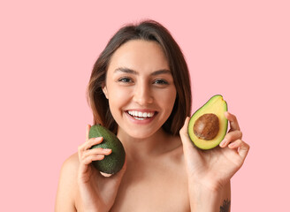 Naked young woman with fresh avocado on color background. Vegan Day