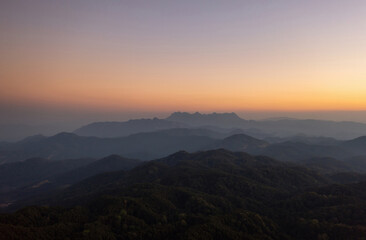 Fototapeta premium Aerial View of Doi chiang dao mountains in the morning and the sea of mist, Doi Kham Fa. Chiang Mai Province, Thailand. Pink cherry blossom.