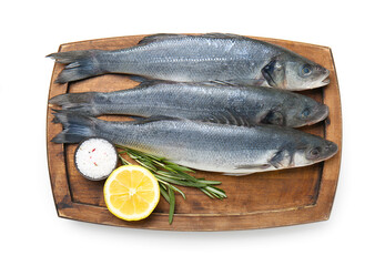 Wooden board with fresh uncooked sea bass fish on white background