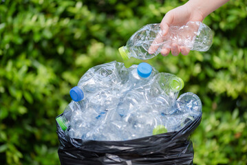 Plastic bottles in black garbage bags waiting to be taken to recycle.