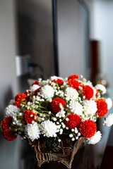 Red and white flowers on a flower pot made of wood, interior decoration, interior design, plastic flowers