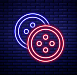 Fototapeta premium Glowing neon line Sewing button for clothes icon isolated on brick wall background. Clothing button. Colorful outline concept. Vector