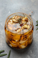 Jar of Cheese with olive oil and rosemary. vertical image. top view. place for text