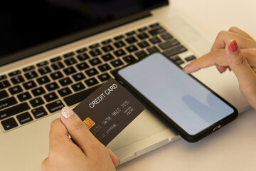 Concept image of credit card and cell phone with blank screen concept. Online payments and financial transactions