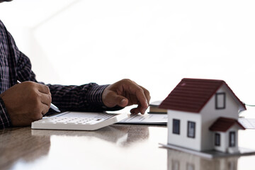 Businessman or home sales representative working in the office with contract documents and...
