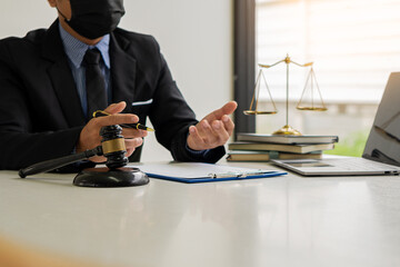 judge, male lawyer, business consultant legal services and consulting in various contracts to plan a court case hammer and scales of justice Businessman in a suit working on paperwork. Law
