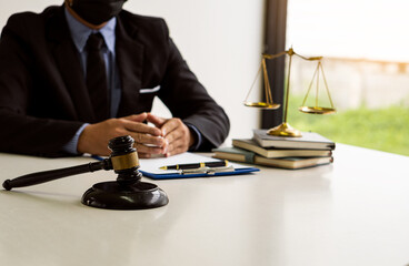 judge, male lawyer, business consultant legal services and consulting in various contracts to plan a court case hammer and scales of justice Businessman in a suit working on paperwork. Law