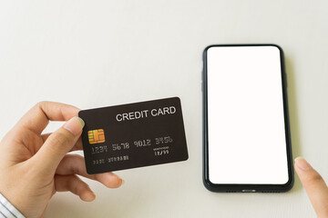 Concept image of credit card and cell phone with blank screen concept. Online payments and financial transactions