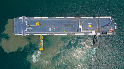 Aerial view car carrier and tugboat at car shipping out of trade port, Large RoRo (Roll on/off)...