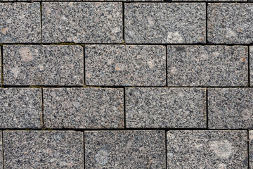 The road is paved with gray stones, top view. stone texture, outdoor stone tiles