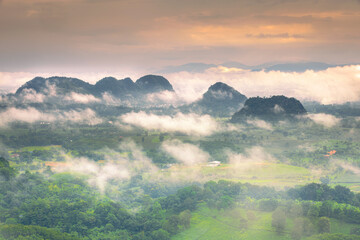 Aerial view of Sun rise with fog Over City and mountain range at Chiangrai Thailand, date photo taken 20 October 2021