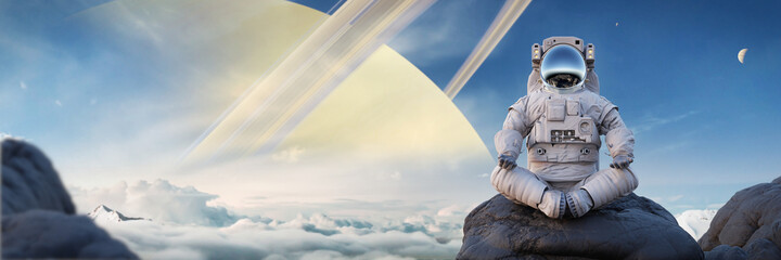 astronaut meditating on the surface of Saturn's moon Titan © dottedyeti