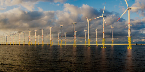 Offshore wind farm at beautiful, dramatic sunset