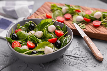 Fresh salad with mozzarella cheese, tomato and spinach. Healthy dieting food.