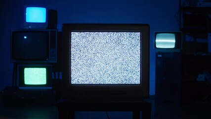 Retro old televisions on blue neon background. Collection of ancient, old-styled vintage TV with grey screens, bad signal reception, ripples and interference, cinematography concept.