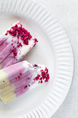 homemade vegan popsicle with berries, matcha tea and freeze-dried raspberries, view from above