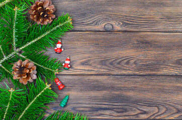 christmas card or background for greeting and design with copy space text, christmas toys and decorations flat lay, frame made of fir tree branch or border for text