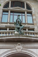 Antwerp, Belgium, a large stone statue in front of a window