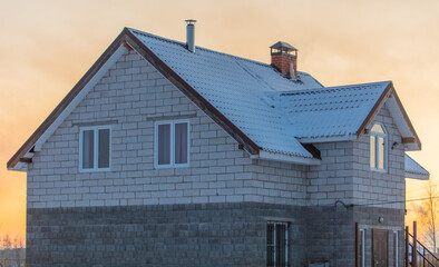 Brick house with snow on the roof