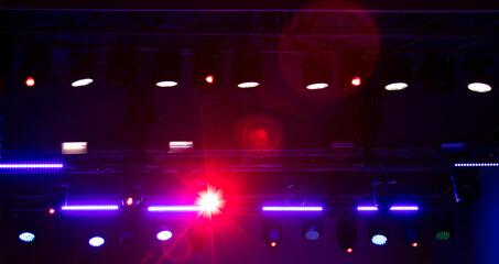 Blue-pink spotlights at a concert at night.