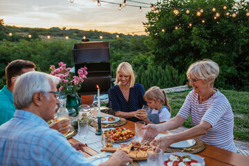 Happy family having fun together at barbecue backyard party