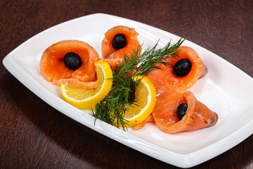 Sliced salmon snack with lemon
