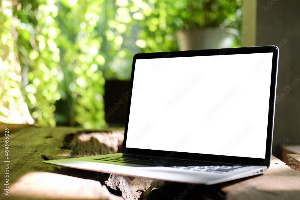 Aufkleber close up view computer laptop with empty screen on wooden table in the garden.