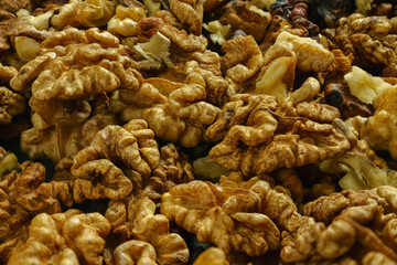 A pile of peeled walnuts in close-up. Selective focus. Background image.