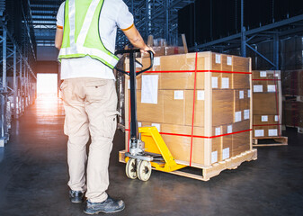 Warehouse Worker Unloading Hand Pallet jack with Package Boxes. Supply Chain in Storage Warehouse Shipping Cargo Warehouse Logistics.	
