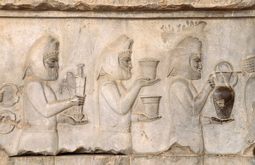 Ancient wall with bas-relief with foreign ambassadors with gifts and donations, Persepolis, Iran
