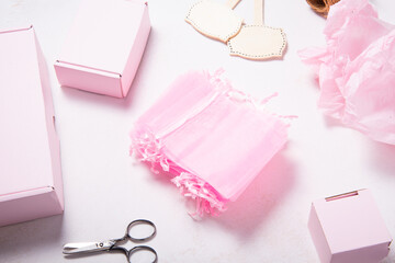 Lot of pink organza gift boxes on wooden desk