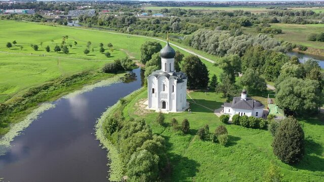Drone view of the ancient white-stone Church of the Intercession on the Nerl on a summer day, located in the Vladimir region, Russia.
