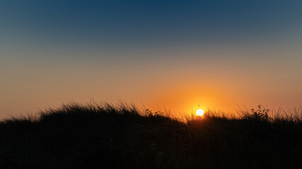 Naklejka na ściany i meble Beautiful sunset at the dunes of the Baltic Sea in Germany