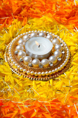Marigold Flower rangoli Design with oil lamps for Diwali Festival.