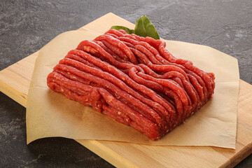 Raw beef minced meat over board