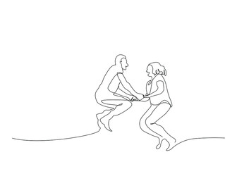 Mature couple having fun together. couple in love jumping in the air holding hands