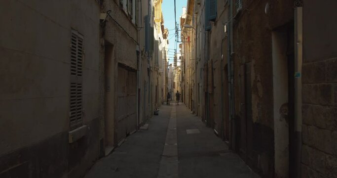 People Walking On Narrow Alley With Old Building Facade Near Town Of La Ciotat, France. Tilt-up