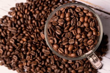 Coffee beans in a glass coffee cup.