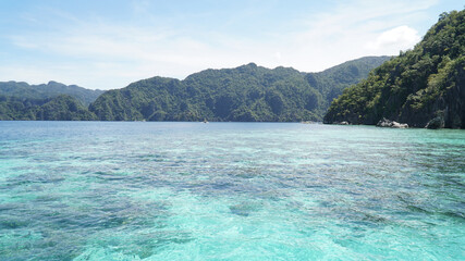 Fototapeta premium Ocean and jagged rock landscapes with turquoise water at Coron Island in Palawan, Philippines.