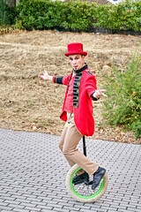 Male performer riding unicycle in park © JoseIMartin