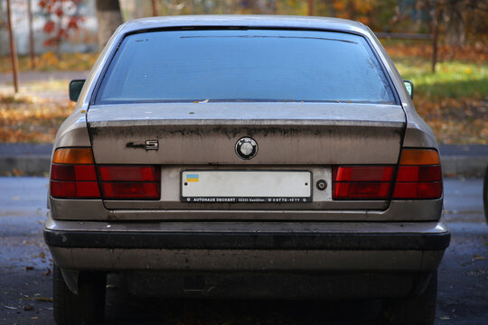 The back of an old shabby German car BMW E34 520i 1994.