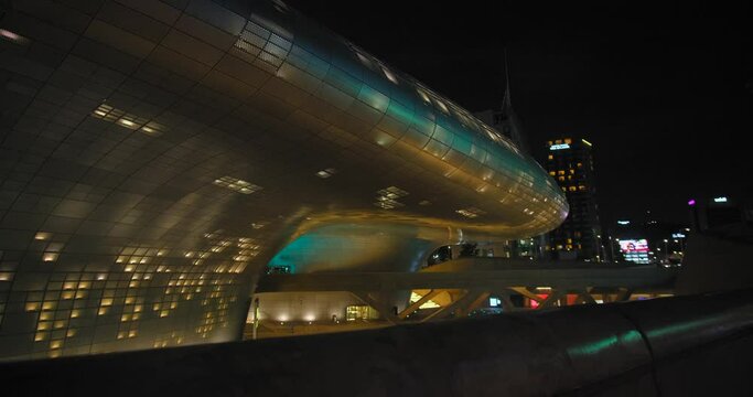 Neofuturistic Exterior Of Dongdaemun Design Plaza (DDP) In Seoul, South Korea At Night. Popular Tourist Attraction In Asia. ascending shot
