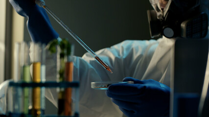 Cropped shot of doctor working on coronavirus vaccine using micropipette and petri dish