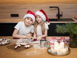 Children - a boy and a girl are preparing gingerbread in the kitchen
