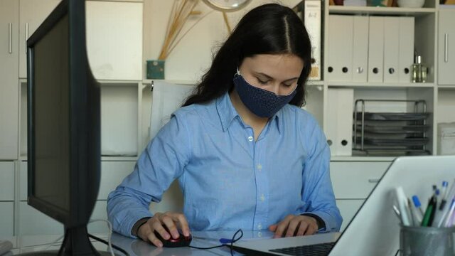 Portrait of business woman in protective mask in modern office interior. High quality 4k footage